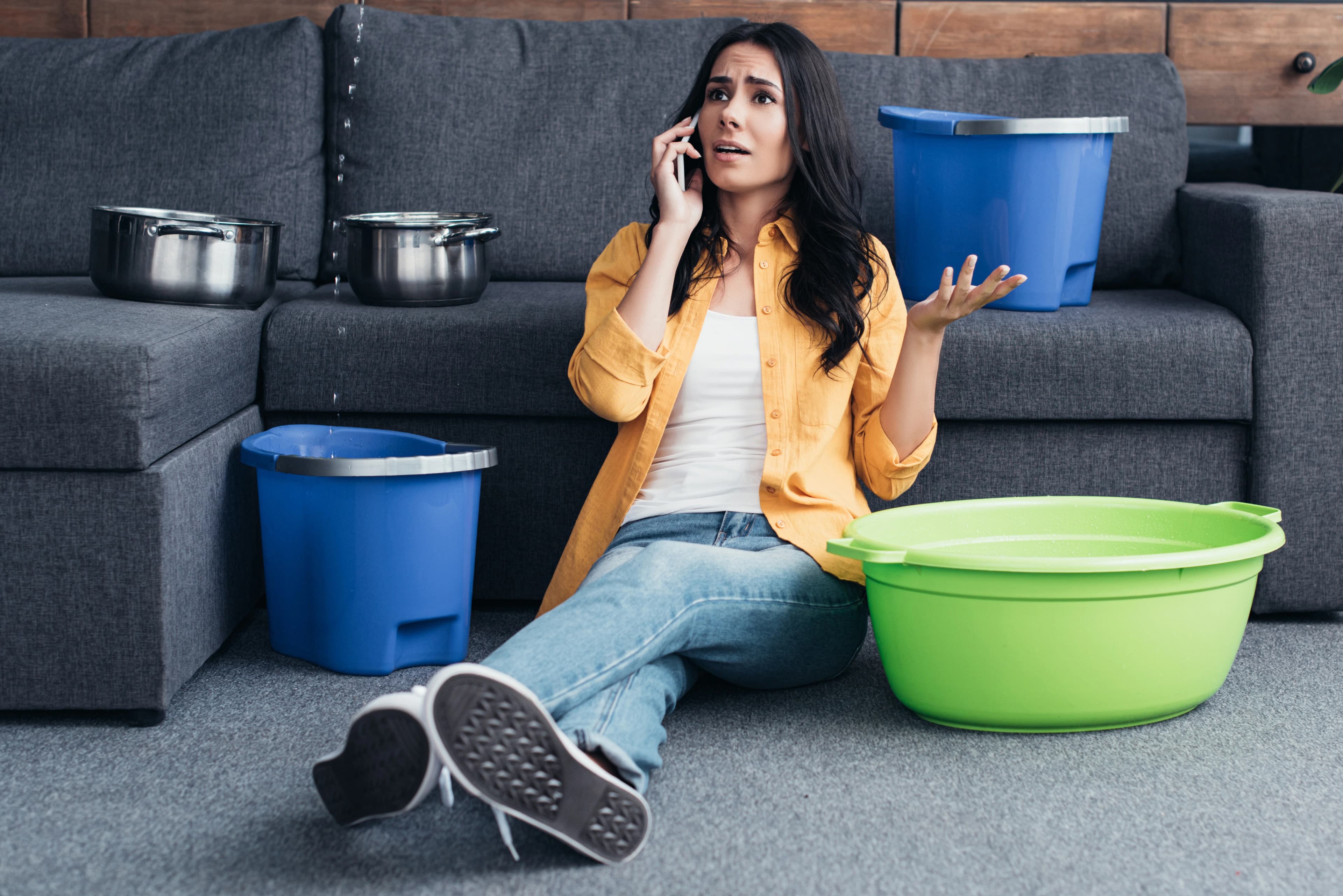 Woman Calling Ceiling Leak Buckets